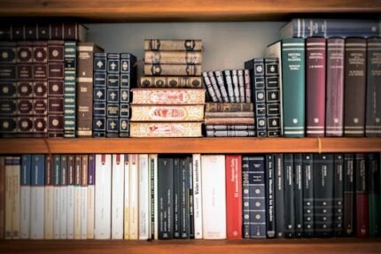 A detailed view of a bookshelf with vintage and classic books arranged neatly, offering a historic ambiance.